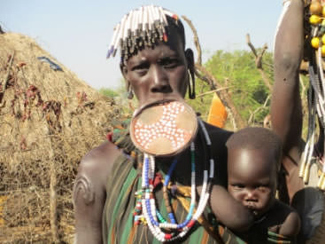 Mursi wearing a large. clay lip plate